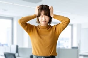 頭を抱えて困る女性